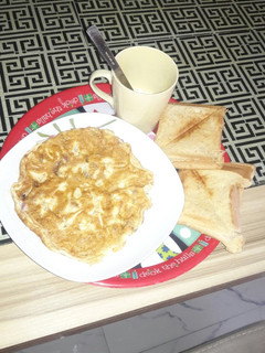 A picture of Plain fried egg and toasted bread.