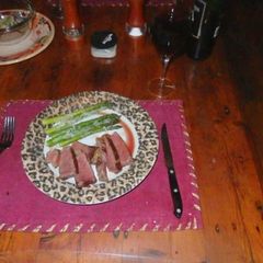 A picture of Sous vide aged prime strip steak with parmesan Asparagus.