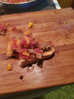 A picture of Sausage scramble on Italian bread.
