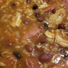 A picture of Rice and beans with smoked sausage and shredded chicken.