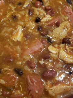 A picture of Rice and beans with smoked sausage and shredded chicken.