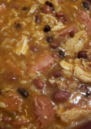 A picture of Rice and beans with smoked sausage and shredded chicken.