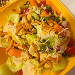 A picture of Fresh salad with dressing.