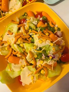 A picture of Fresh salad with dressing.
