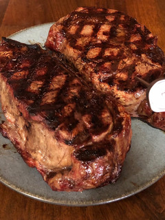 A picture of 3 inch thick ribeye steak on BBQ.