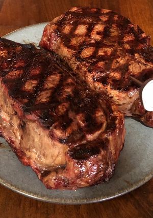 A picture of 3 inch thick ribeye steak on BBQ.