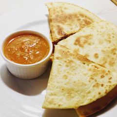 A picture of Chicken Quesadillas with salsa.