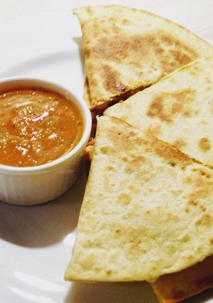 A picture of Chicken Quesadillas with salsa.