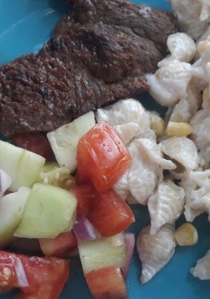A picture of Barbecue Beef Steak with Pasta Shell Salad and Vegetable Salad.