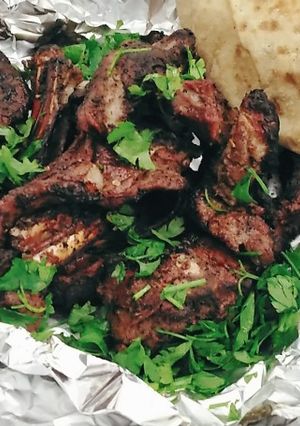 A picture of Grilled Lamb Chops over Charcoal.