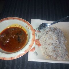 A picture of Rice and beans with stew.