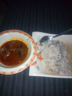 A picture of Rice and beans with stew.