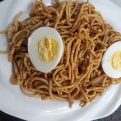 A picture of Spagetti with boiled egg.