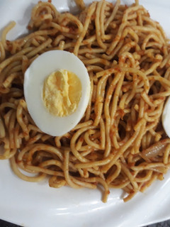 A picture of Spagetti with boiled egg.