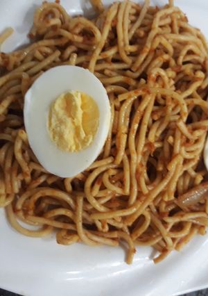 A picture of Spagetti with boiled egg.