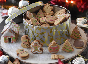 A picture of Stuffed gingerbread cookies & small gingerbread home.