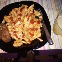 A picture of French fries, coated chicken and fresh pineapple juice....