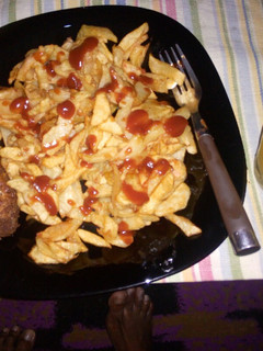 A picture of French fries, coated chicken and fresh pineapple juice....