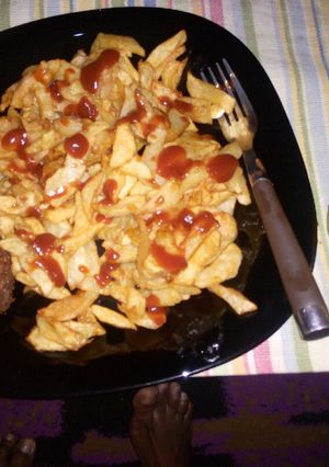 A picture of French fries, coated chicken and fresh pineapple juice....