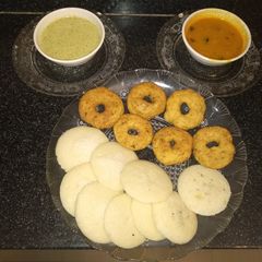 A picture of Idli vada with coconut chutney and sambhar.