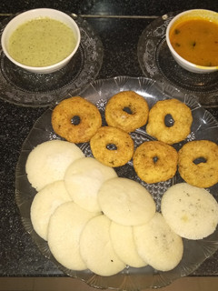 A picture of Idli vada with coconut chutney and sambhar.