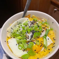 A picture of Creamy Turmeric Congee with Fried Eggs.