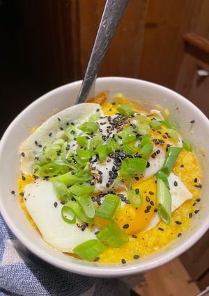 A picture of Creamy Turmeric Congee with Fried Eggs.