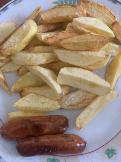 A picture of Chips and sausage#staplefoodrecipecontest.