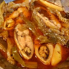 A picture of Hilsa or Elish curry with brinjol and potato.