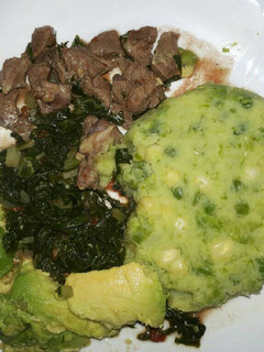 A picture of Mukimo served with goat fry and veges.