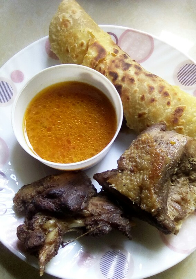A picture of Deep fried duck served with soup and chapati.