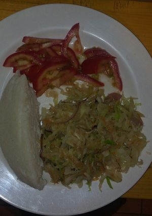 A picture of Ugali with steamed cabbage.