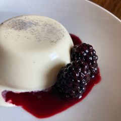 Vanilla panna cotta with blackberry sauce A picture of Vanilla panna cotta with blackberry sauce.