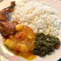 A picture of Cassava leaves (Kisamvu) and potato & tomato sauce.