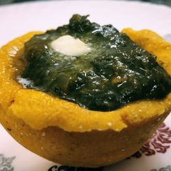 A picture of Makki cup filled with sarson ka saag.