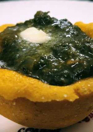 A picture of Makki cup filled with sarson ka saag.