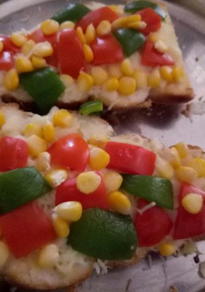 A picture of Garlic bread with toppings.