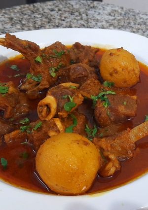 A picture of Mutton Curry With Whole Potatoes.
