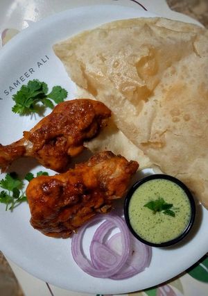 A picture of Steamed chicken tikka with puri paratha.