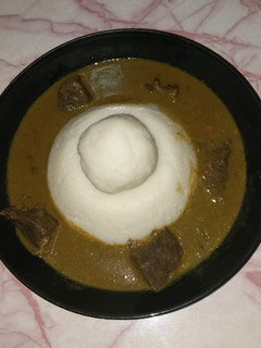 A picture of Tuwon Shinkafa in a pool of Miyan Kuka.