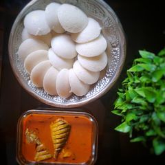 A picture of South Indian manglore fish curry and Idli.