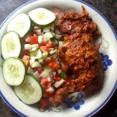 A picture of Peppered chicken with cucumber and tomato salad.