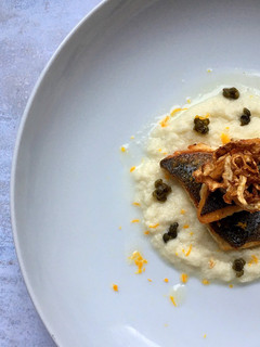 A picture of Pan seared seabass fillet on fennel puree with fennel crisps and crispy capers.
