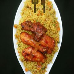 A picture of Vegetable jollof rice with ppe chicken.