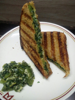 A picture of Spinach Capsicum cheese Sandwich (brown bread) (jain/regular).