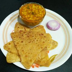 A picture of Bengal gram sabji and paratha.