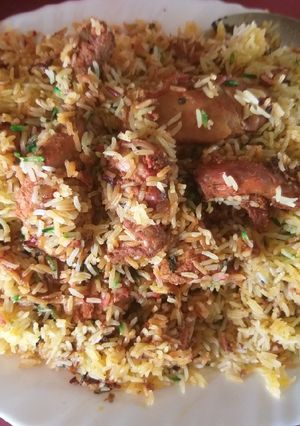 A picture of Chicken tikka biryani with boondi raita.
