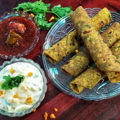 A picture of Methi Thepla with boondi Raita and Sweet Mango pickle.
