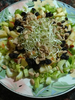 Una foto de Ensalada de apio, manzana, pasas de uva, maní y brotes de fenogreco