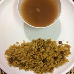 Brown Chanapoha and rasam A picture of Brown Chanapoha and rasam.